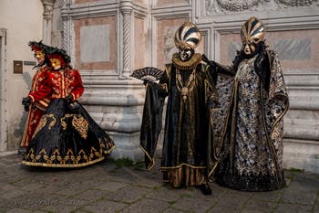 Venetian carnival costumed figures in front of the church of San Zaccaria.