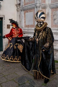 Venetian carnival costumed figures in front of the church of San Zaccaria.