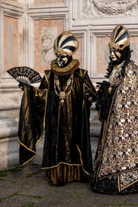 Venetian carnival costumed figures in front of the church of San Zaccaria.