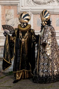 Venetian carnival costumed figures in front of the church of San Zaccaria.