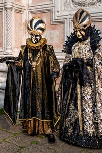 Venetian carnival costumed figures in front of the church of San Zaccaria.