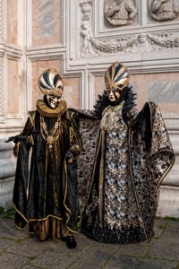 Venetian carnival costumed figures in front of the church of San Zaccaria.