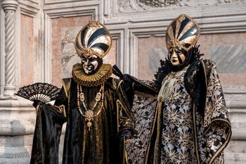 Venetian carnival costumed figures in front of the church of San Zaccaria.