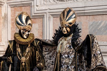 Venetian carnival costumed figures in front of the church of San Zaccaria.