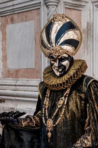 Venetian carnival costumed figures in front of the church of San Zaccaria.