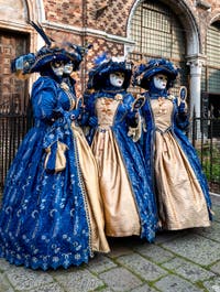 Venetian carnival costumed figures in front of the church of San Zaccaria.