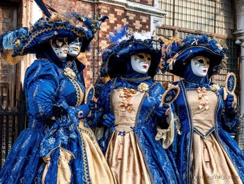 Venetian carnival costumed figures in front of the church of San Zaccaria.