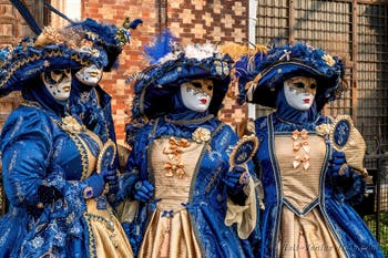 Venetian carnival costumed figures in front of the church of San Zaccaria.