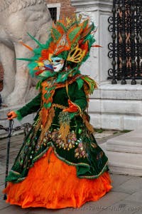 People in costume at the Venice Carnival in front of the Venetian Arsenal.