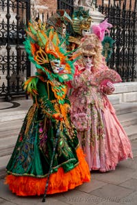 People in costume at the Venice Carnival in front of the Venetian Arsenal.