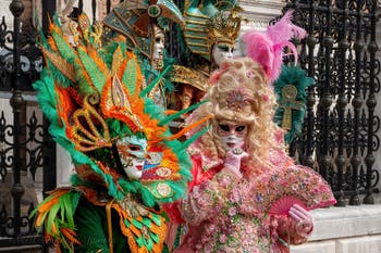 People in costume at the Venice Carnival in front of the Venetian Arsenal.