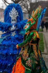 People in costume at the Venice Carnival in front of the Venetian Arsenal.