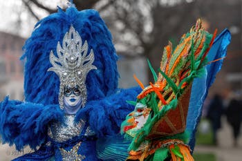 People in costume at the Venice Carnival in front of the Venetian Arsenal.