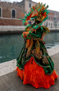 People in costume at the Venice Carnival in front of the Venetian Arsenal.