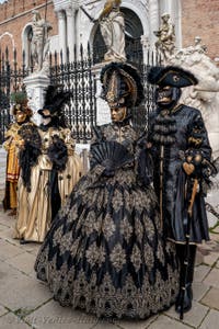 People in costume at the Venice Carnival in front of the Venetian Arsenal.