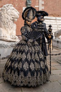 People in costume at the Venice Carnival in front of the Venetian Arsenal.