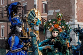 People in costume at the Venice Carnival in front of the Venetian Arsenal.