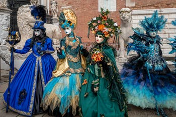 People in costume at the Venice Carnival in front of the Venetian Arsenal.