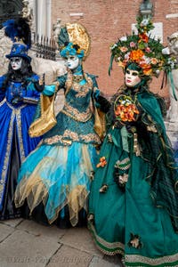 People in costume at the Venice Carnival in front of the Venetian Arsenal.