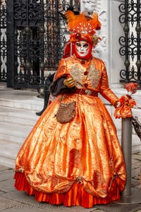 People in costume at the Venice Carnival in front of the Venetian Arsenal.