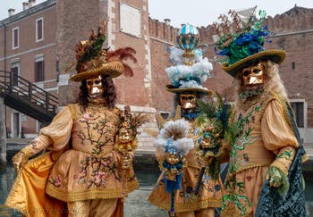 People in costume at the Venice Carnival in front of the Venetian Arsenal.