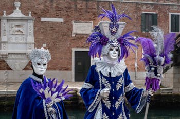 People in costume at the Venice Carnival in front of the Venetian Arsenal.