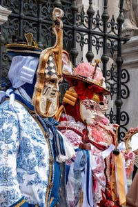 People in costume at the Venice Carnival in front of the Venetian Arsenal.