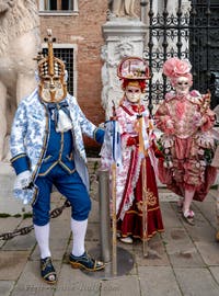 People in costume at the Venice Carnival in front of the Venetian Arsenal.