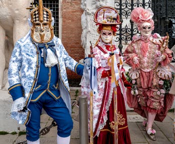 People in costume at the Venice Carnival in front of the Venetian Arsenal.