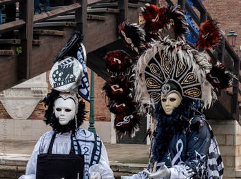 People in costume at the Venice Carnival in front of the Venetian Arsenal.