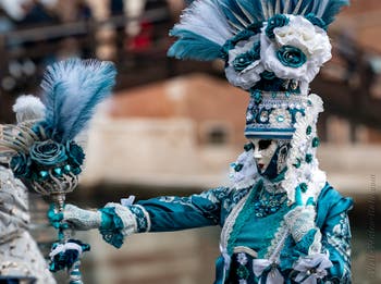 People in costume at the Venice Carnival in front of the Venetian Arsenal.