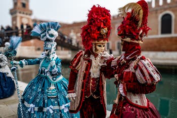 People in costume at the Venice Carnival in front of the Venetian Arsenal.