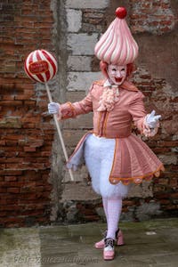 People in costume at the Venice Carnival in front of the Venetian Arsenal.