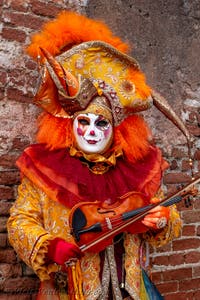 People in costume at the Venice Carnival in front of the Venetian Arsenal.