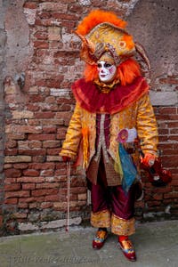 People in costume at the Venice Carnival in front of the Venetian Arsenal.