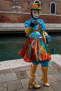 People in costume at the Venice Carnival in front of the Venetian Arsenal.