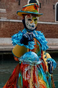 People in costume at the Venice Carnival in front of the Venetian Arsenal.