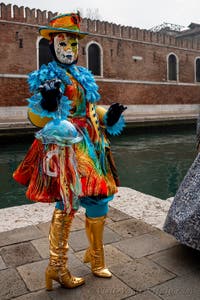 People in costume at the Venice Carnival in front of the Venetian Arsenal.