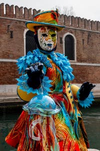 People in costume at the Venice Carnival in front of the Venetian Arsenal.