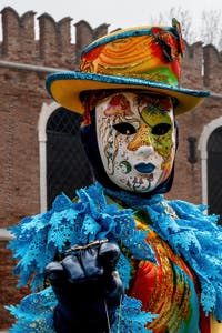 People in costume at the Venice Carnival in front of the Venetian Arsenal.