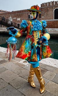 People in costume at the Venice Carnival in front of the Venetian Arsenal.