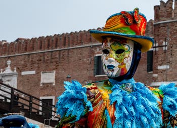 People in costume at the Venice Carnival in front of the Venetian Arsenal.