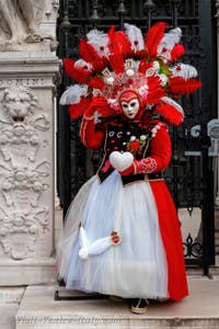 People in costume at the Venice Carnival in front of the Venetian Arsenal.