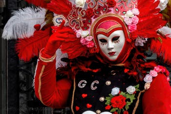 People in costume at the Venice Carnival in front of the Venetian Arsenal.