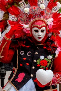 People in costume at the Venice Carnival in front of the Venetian Arsenal.