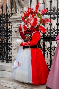 People in costume at the Venice Carnival in front of the Venetian Arsenal.