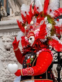 People in costume at the Venice Carnival in front of the Venetian Arsenal.