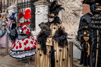 People in costume at the Venice Carnival in front of the Venetian Arsenal.