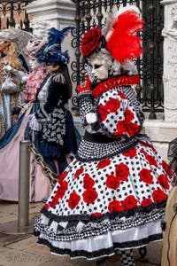 People in costume at the Venice Carnival in front of the Venetian Arsenal.