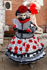 People in costume at the Venice Carnival in front of the Venetian Arsenal.